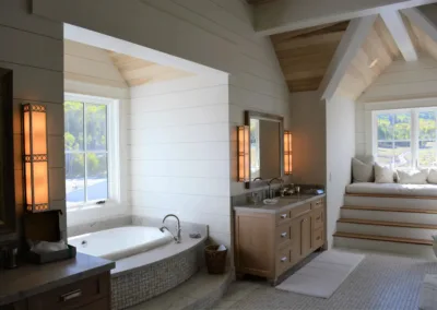 A bathroom with a large window and a bathtub.