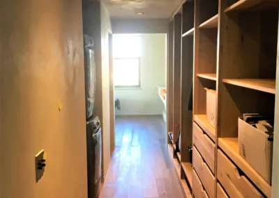 A hallway with a washer and dryer in it.